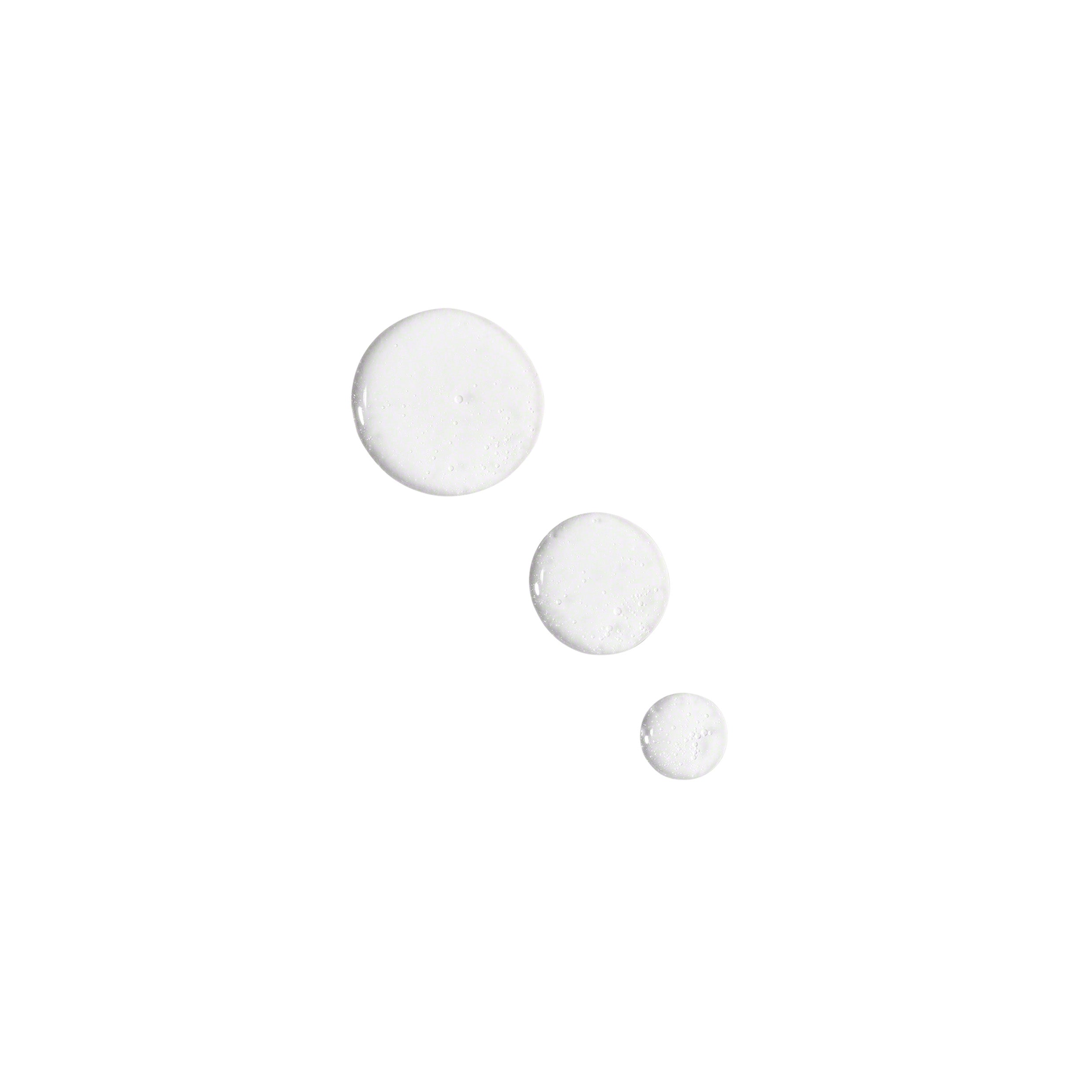 Droplets of Valmont LumiSence, clear liquid shown on a white background.