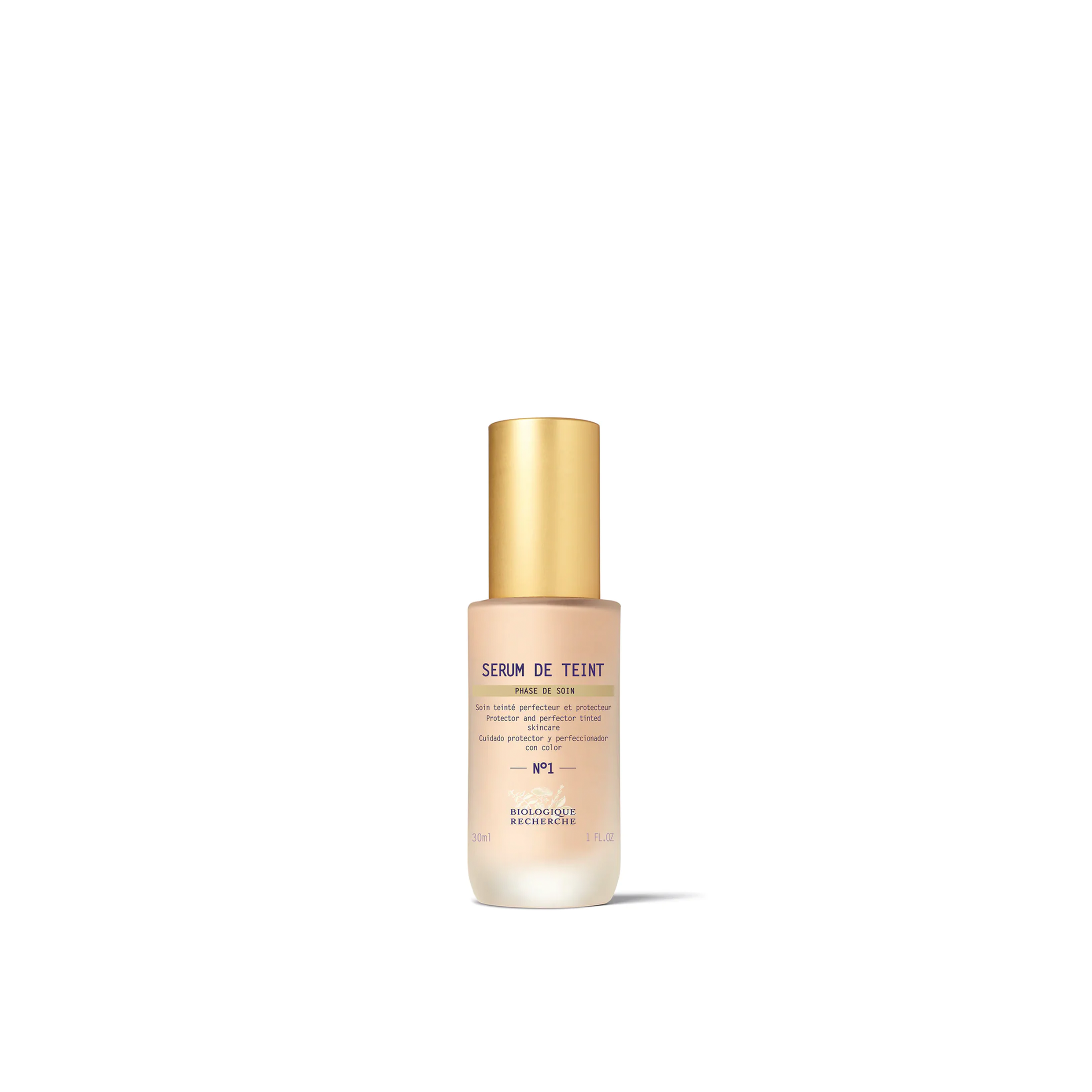 A bottle of Biologique Recherche Serum de Teint with a gold-colored cap and a white label, designed for even skin tone and hydration.