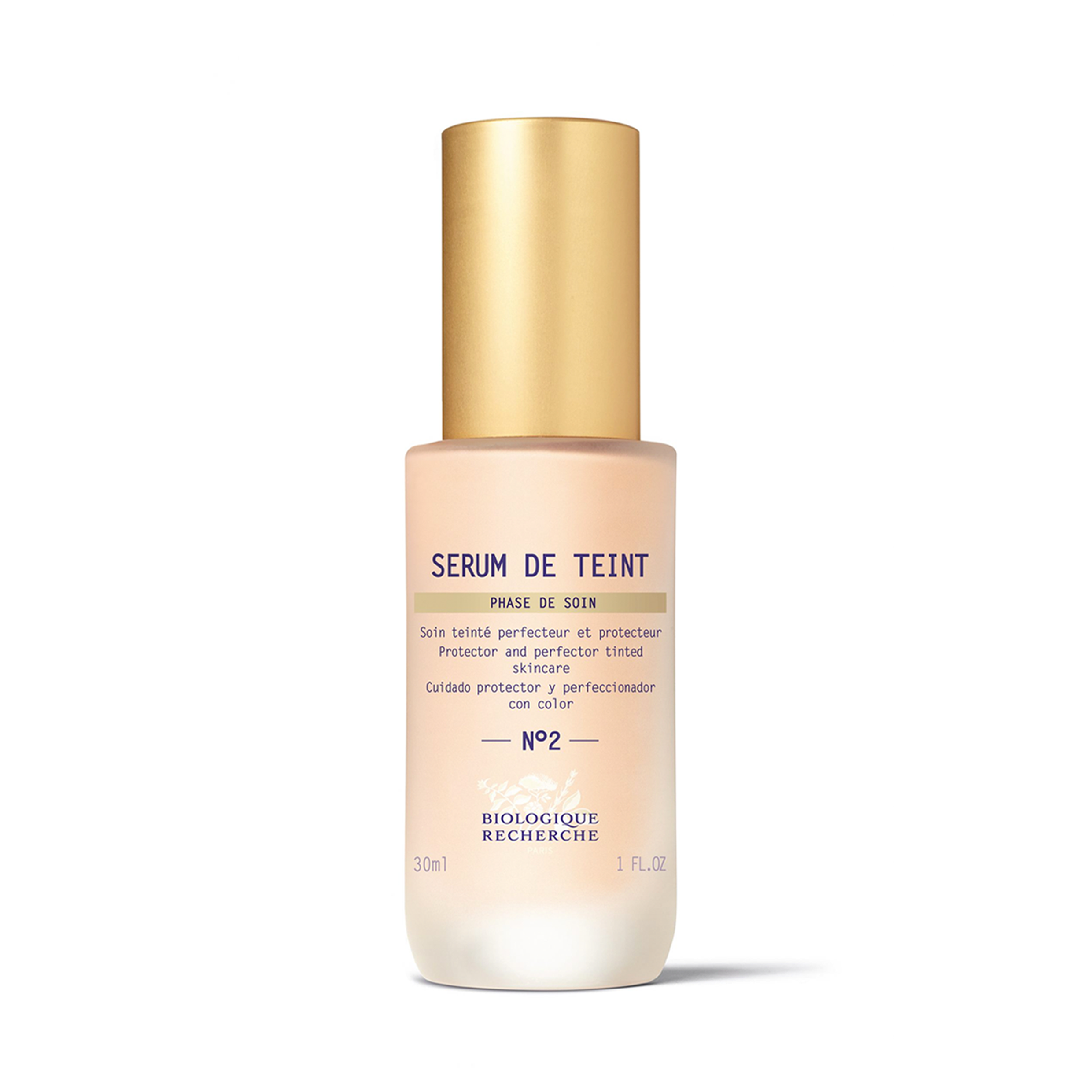 A bottle of Biologique Recherche Serum de Teint with a gold-colored cap and a white label, designed for even skin tone and hydration.