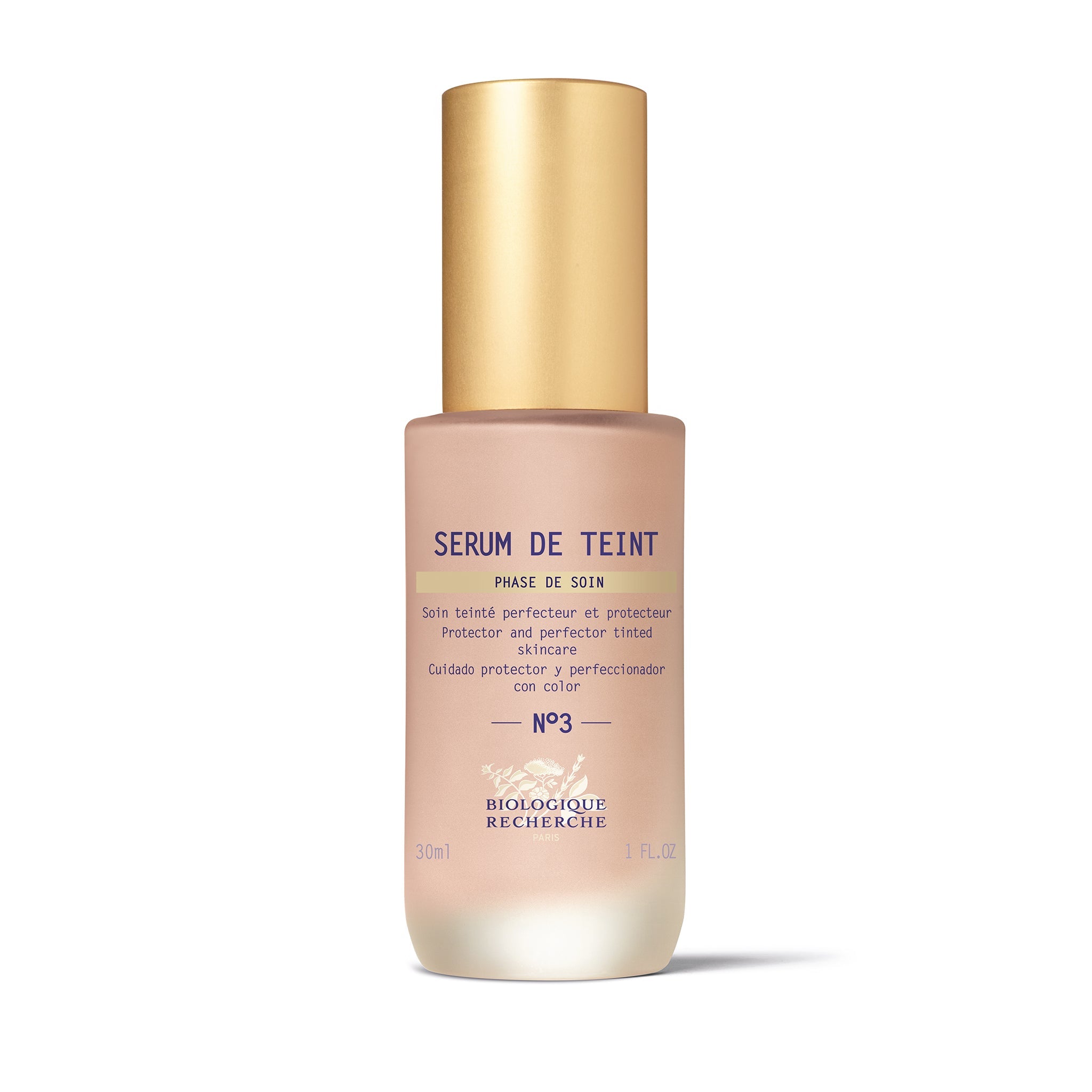A bottle of Biologique Recherche Serum de Teint with a gold-colored cap and a white label, designed for even skin tone and hydration.