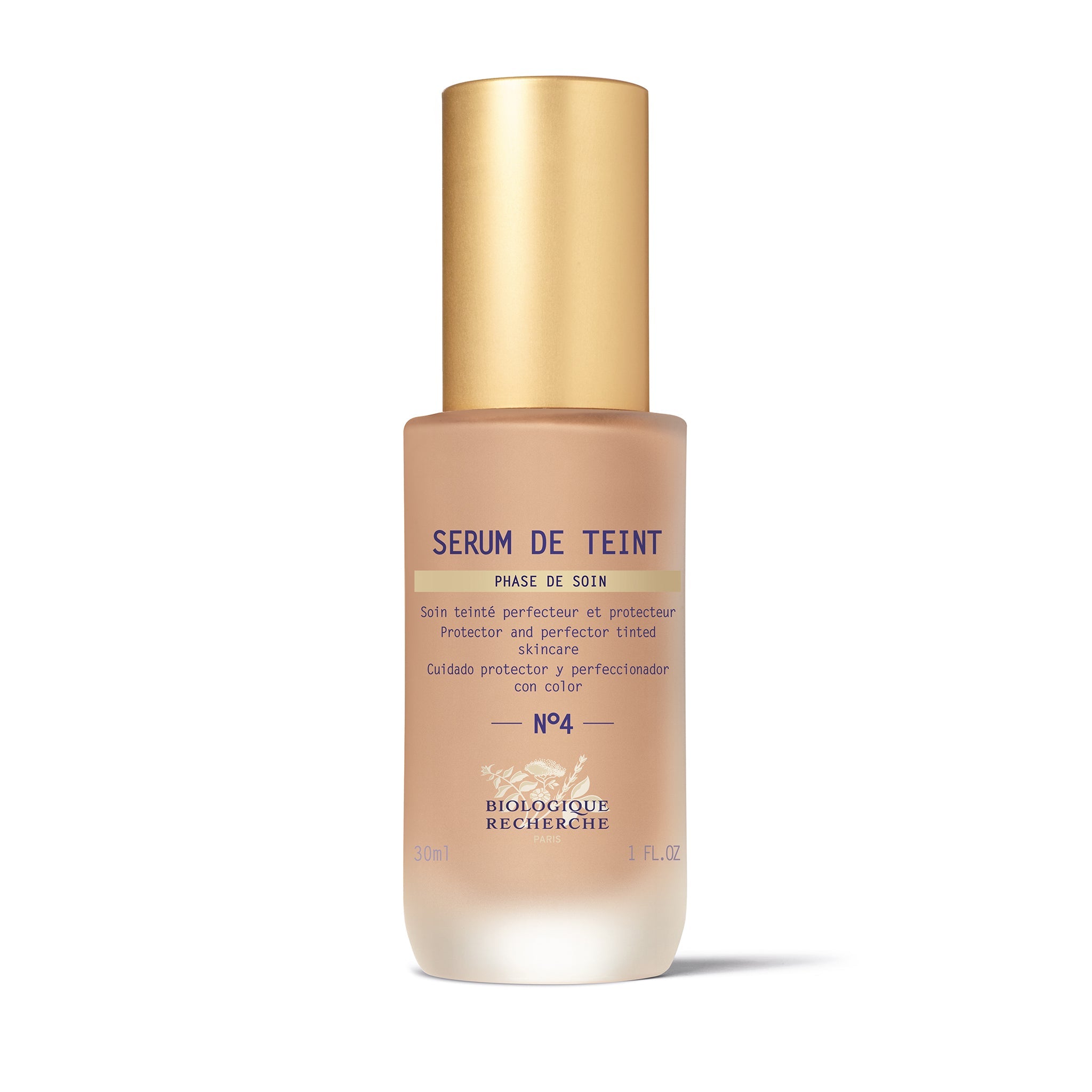 A bottle of Biologique Recherche Serum de Teint with a gold-colored cap and a white label, designed for even skin tone and hydration.