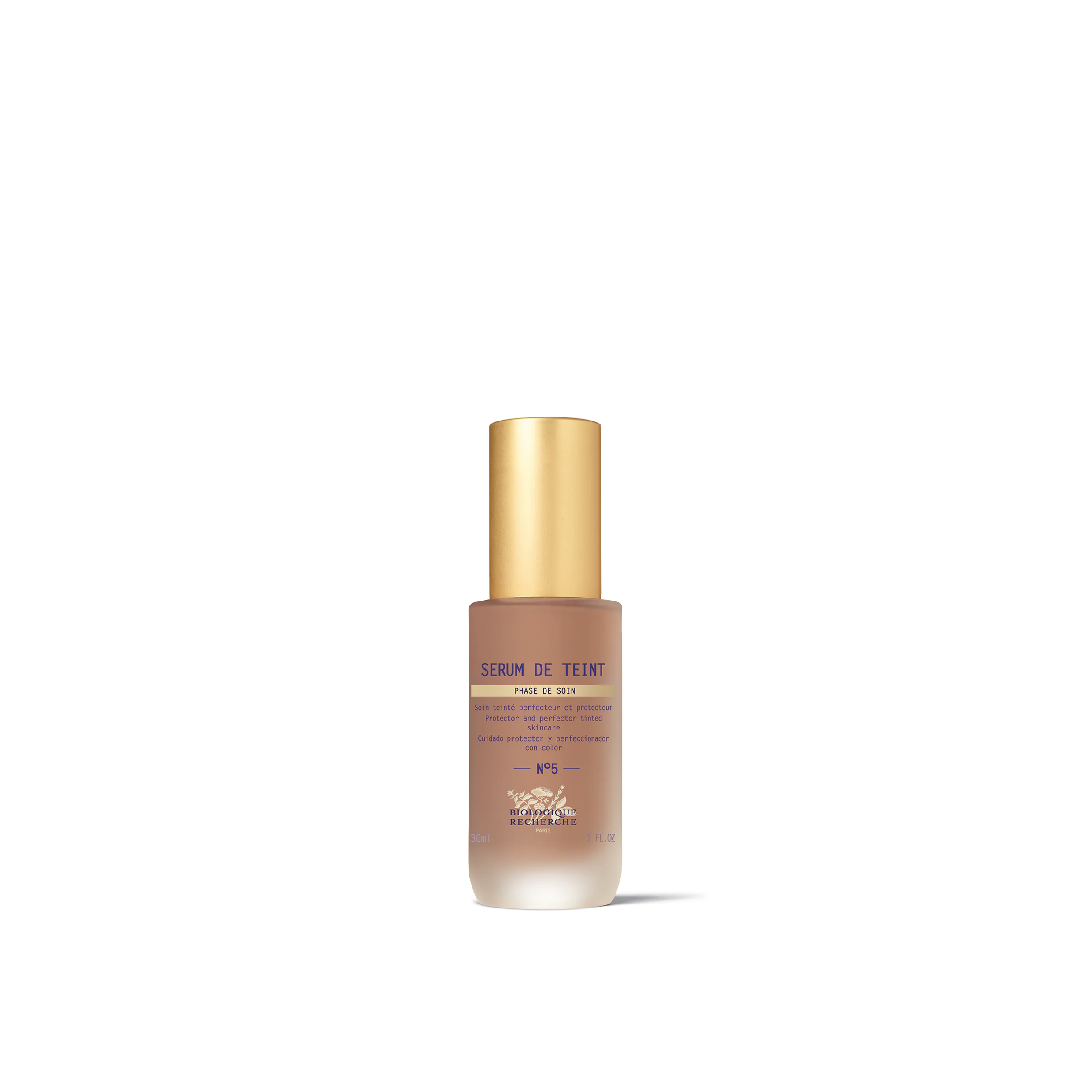 A bottle of Biologique Recherche Serum de Teint with a gold-colored cap and a white label, designed for even skin tone and hydration.