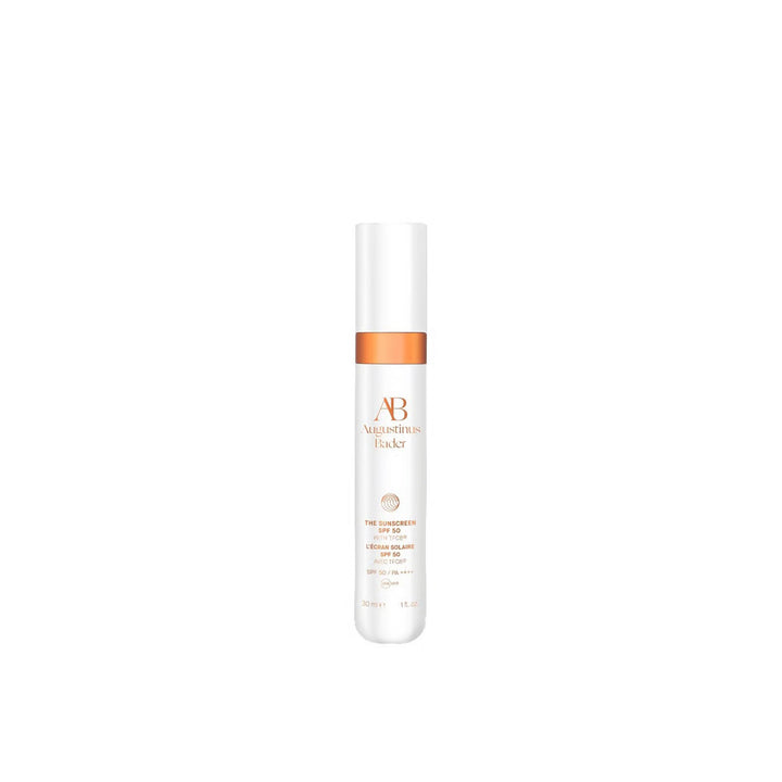 White skincare bottle with orange label on a white background