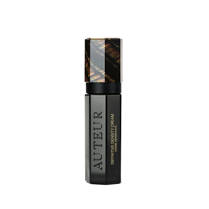 Black cosmetic bottle with gold accents on a white background