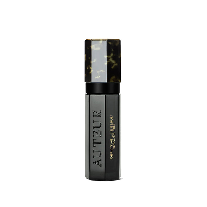 A black and blue bottle of Auteur Definitive Line Serum with a sleek design.