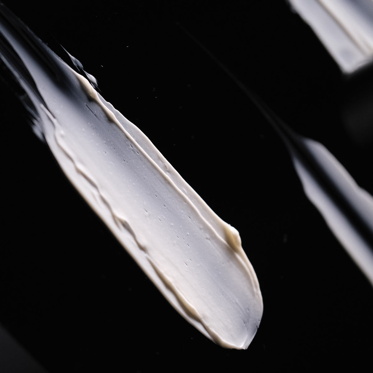 Texture of Auteur Superlative Cream Voyage, a rich ivory cream, on black