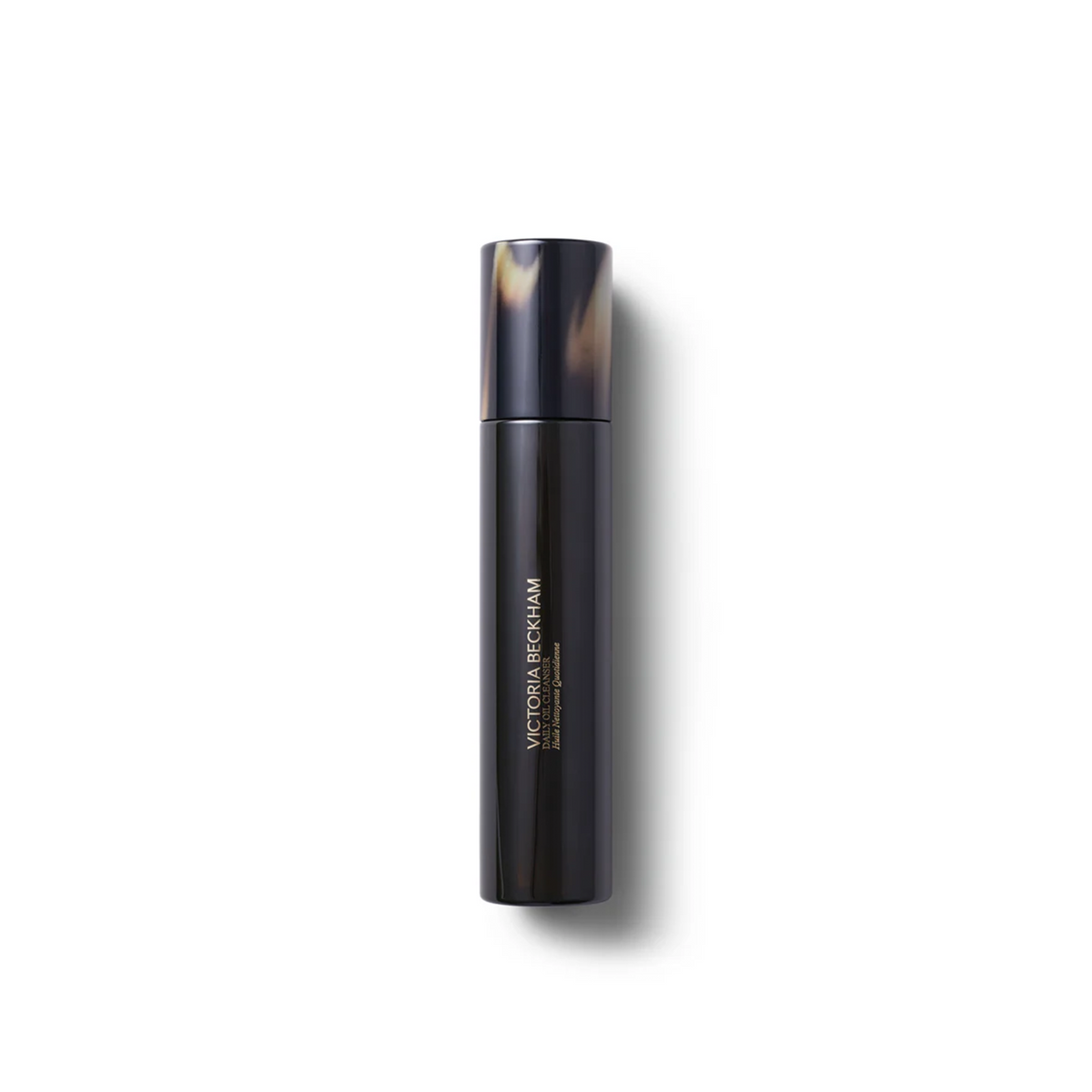 Black cylindrical product with tortoiseshell cap on a white background