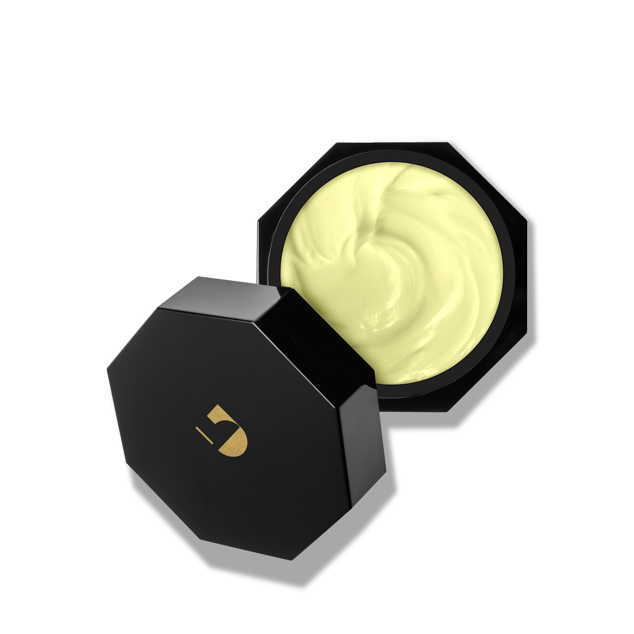 Black container with a swatch of cream on a white background