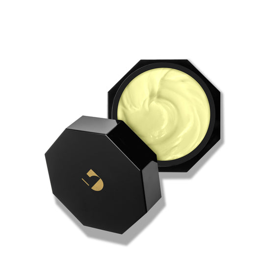 Black container with a swatch of cream on a white background