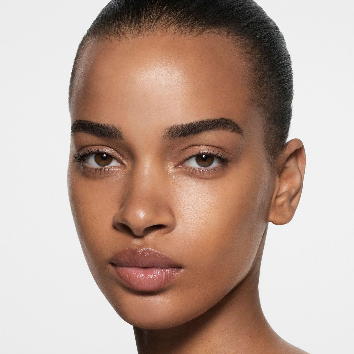 Model wearing Victoria Beckham Beauty The Foundation Drops in shade 10 Medium Dark