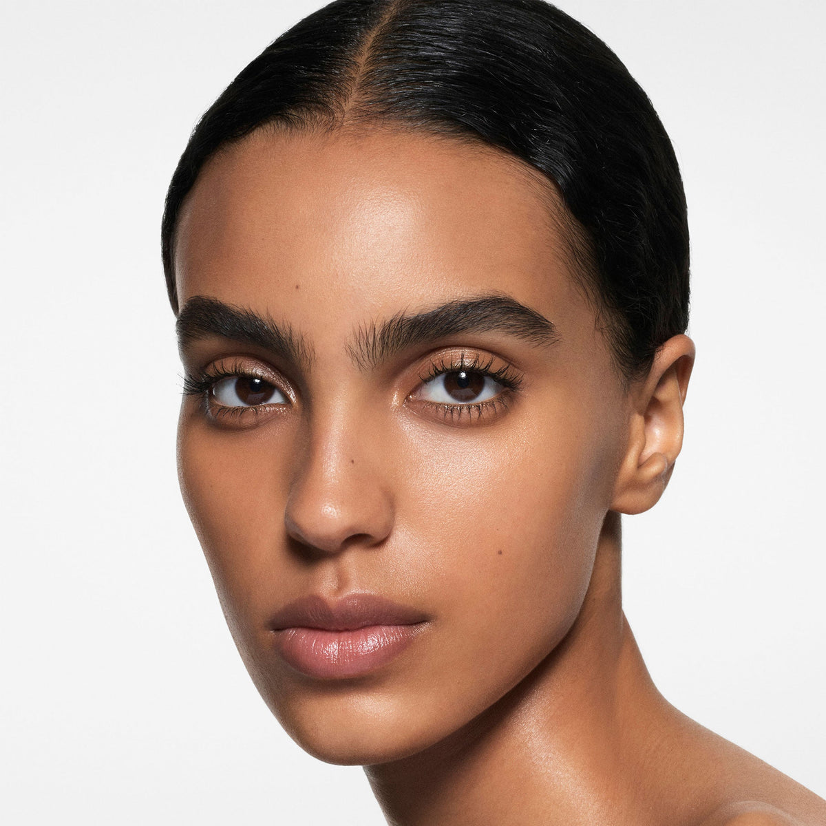 Model wearing Victoria Beckham Beauty The Foundation Drops in shade 11 Medium Dark