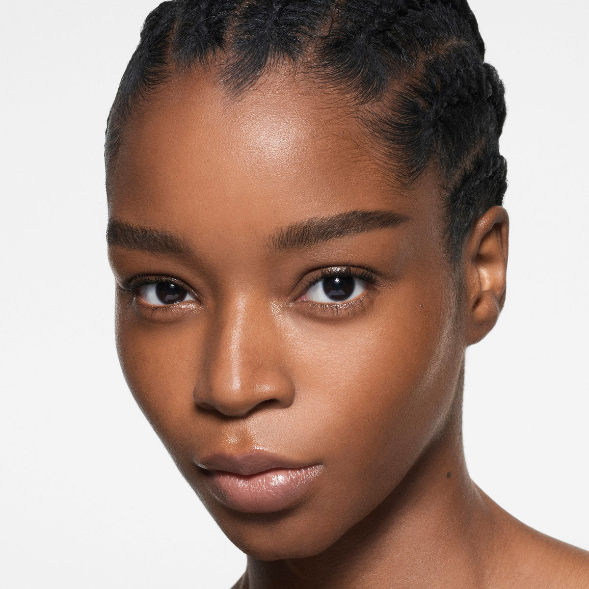 Model wearing Victoria Beckham Beauty The Foundation Drops in shade 13 Dark