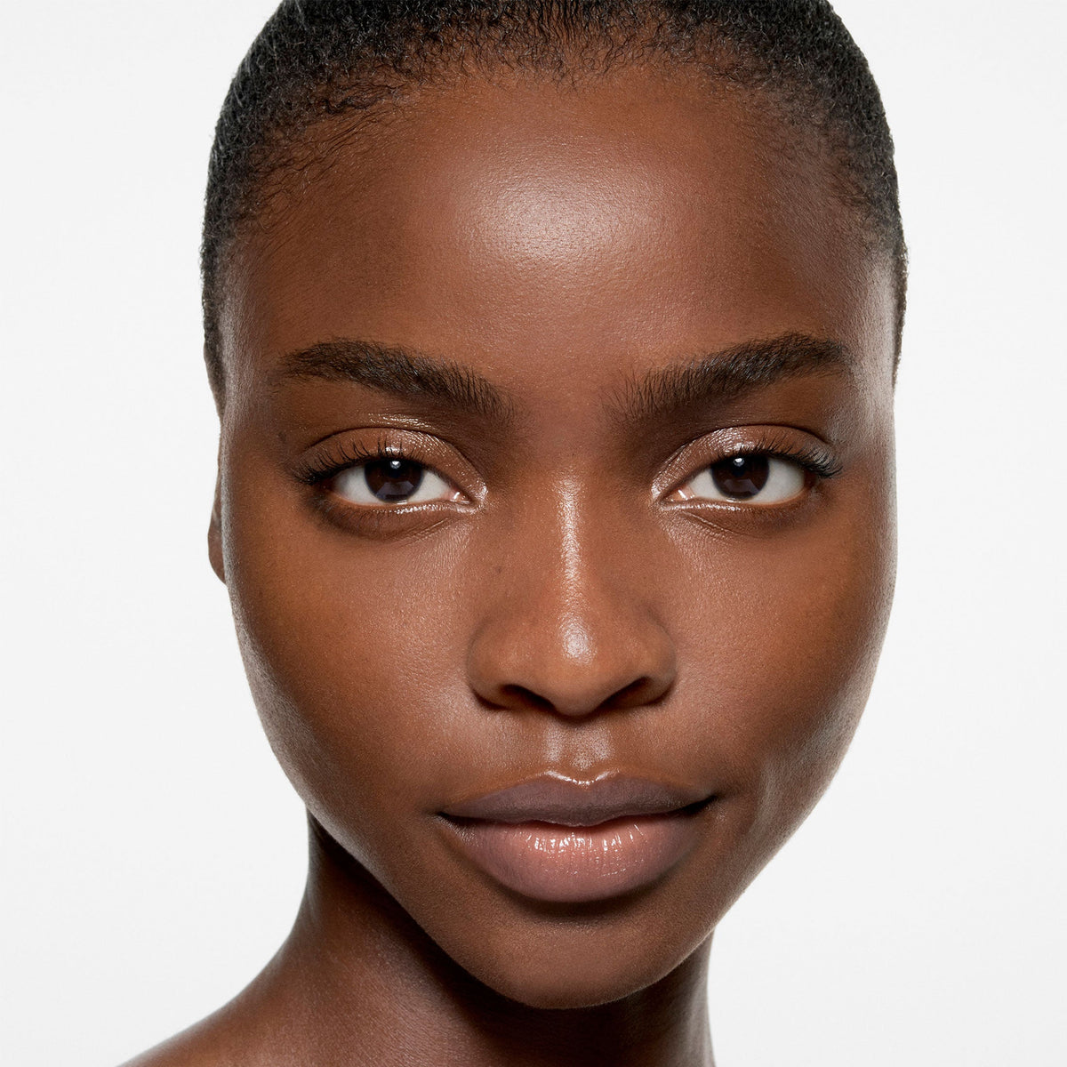 Model wearing Victoria Beckham Beauty The Foundation Drops in shade 14 Dark