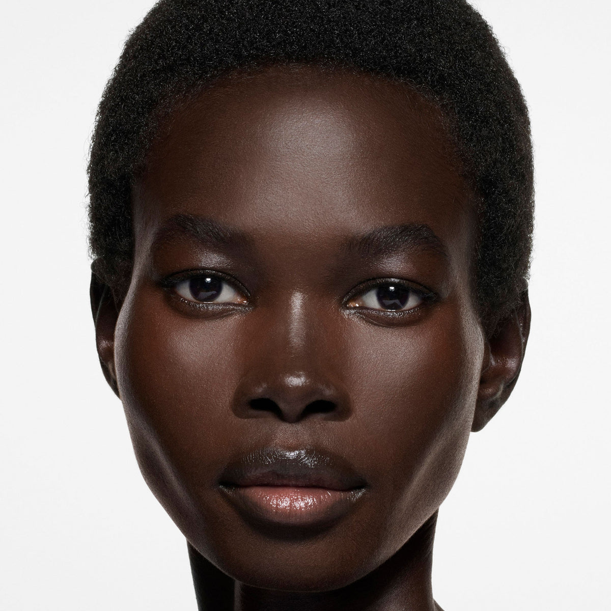 Model wearing Victoria Beckham Beauty The Foundation Drops in shade 18 Rich