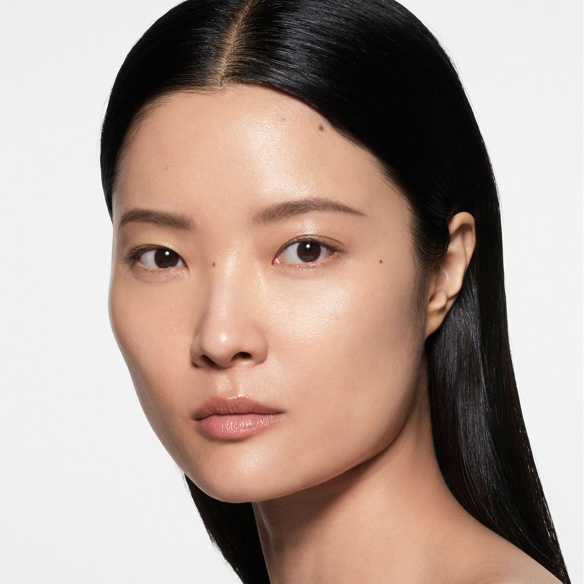 Model wearing Victoria Beckham Beauty The Foundation Drops in shade 5 Light