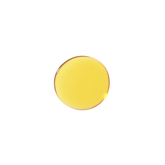 Droplet of yellow face serum on a white background