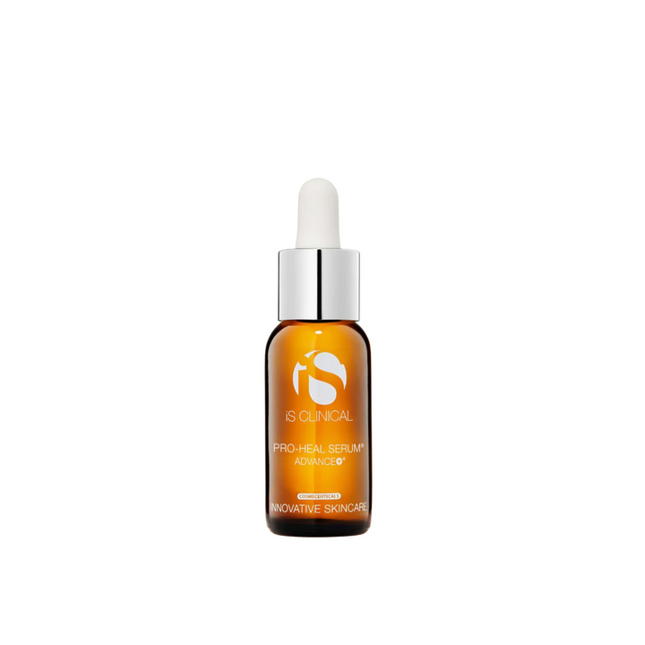 A dropper bottle of iS Clinical Pro Heal Serum Advanced+ with a white and orange label.