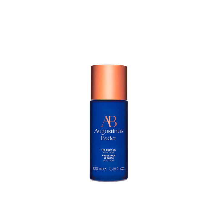 A bottle of body oil in a blue container