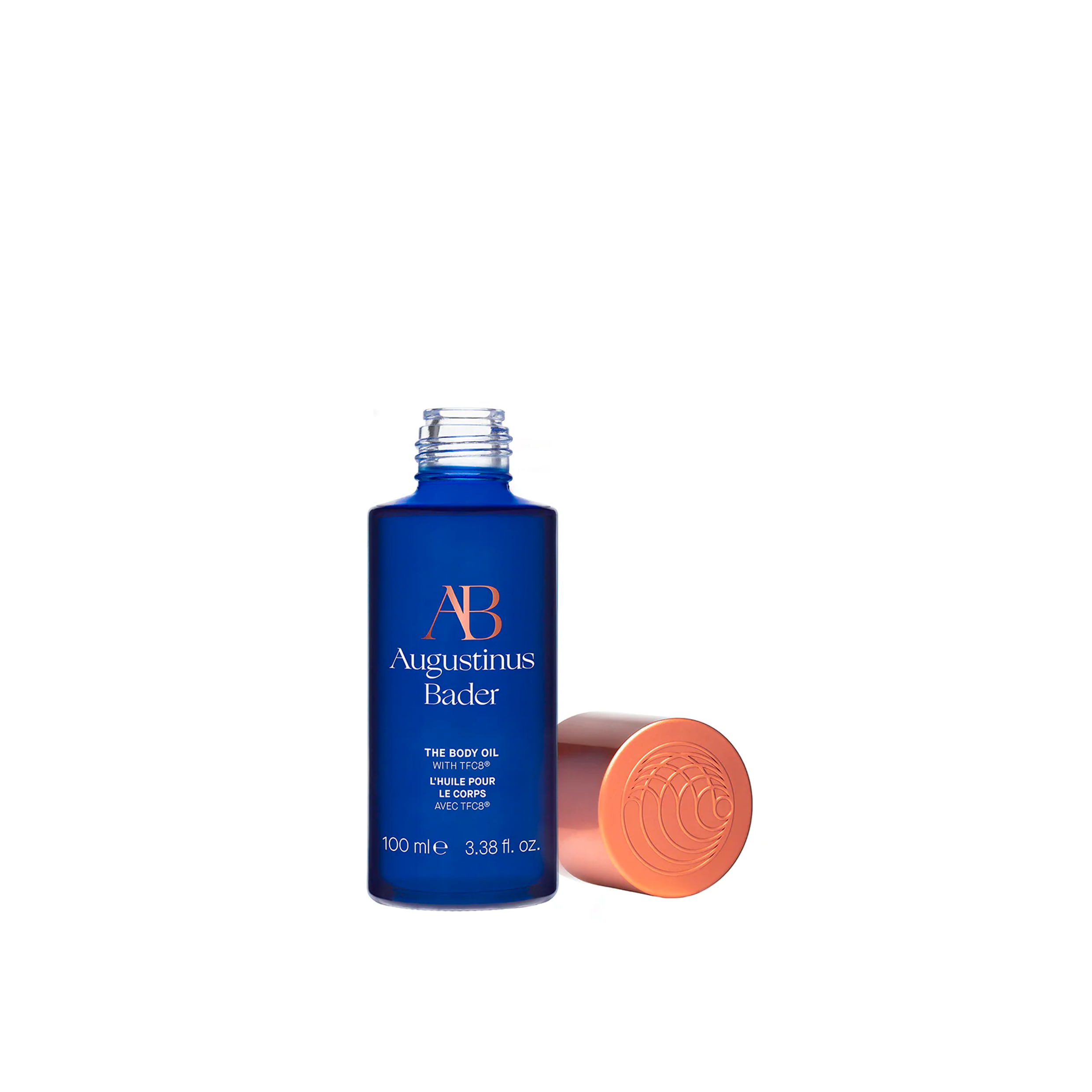 A bottle of body oil with the lid off