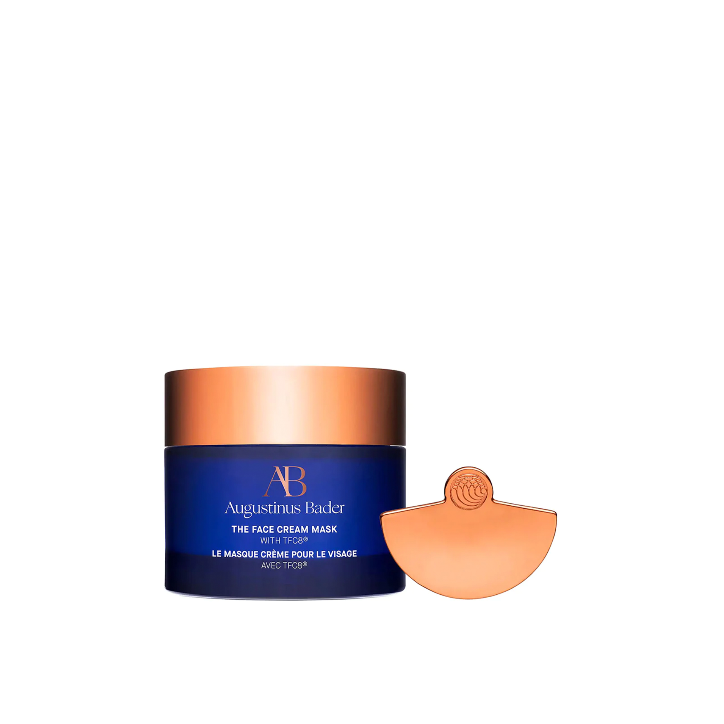 A jar of Augustinus Bader The Face Cream Mask with a spoonful of the cream visible, against a white background.