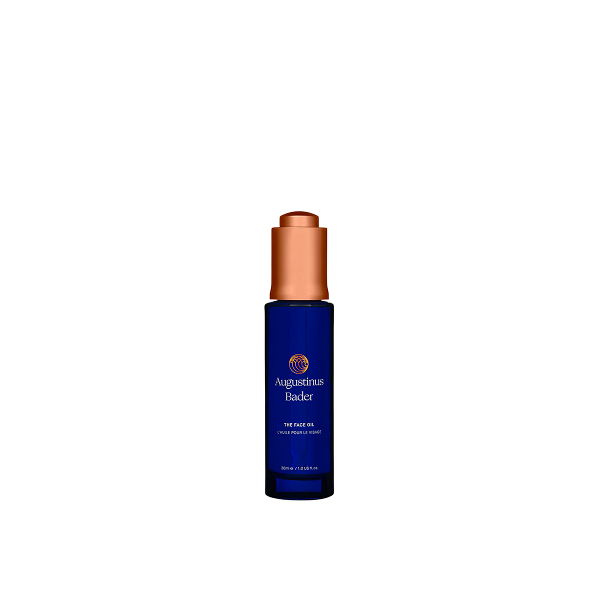 A bottle of Augustinus Bader The Face Oil with a blue label and a copper-colored cap.