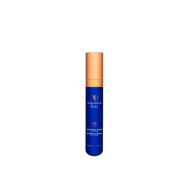 A bottle of Augustinus Bader The Retinol Serum with a blue label and a copper-colored cap.