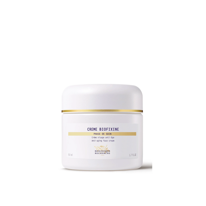 A white jar with a gold band labeled 'Crème Biofixine' from Biologique Recherche.