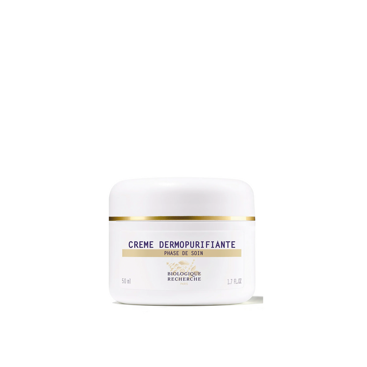 A white jar with a golden lid labeled 'Crème Dermopurifiante' from Biologique Recherche.