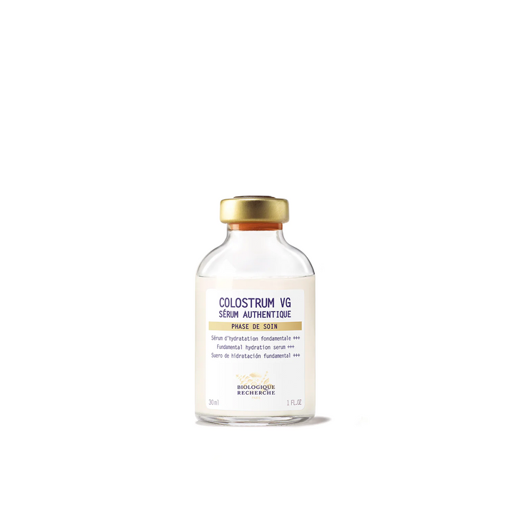 A glass vial of Biologique Recherche Serum Colostrum VG with a white and yellow label, and a gold cap.