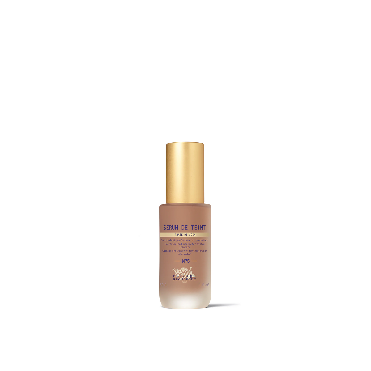 A bottle of Biologique Recherche Serum de Teint with a gold-colored cap and a white label, designed for even skin tone and hydration.