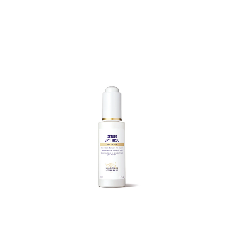 A white bottle with a dropper containing the Biologique Recherche Serum Erythros, designed for calming treatment of redness and sensitivity on the skin.