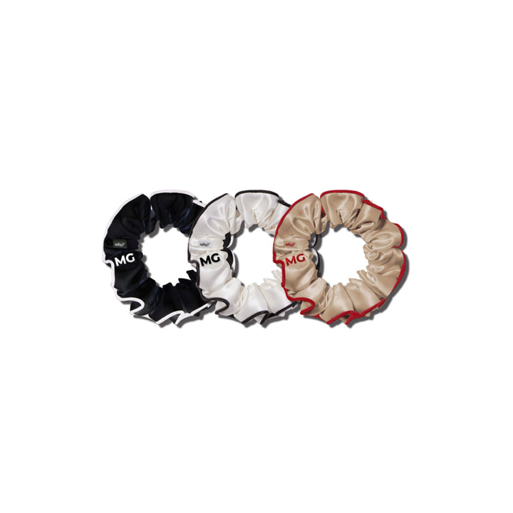 Three multi large scrunchies in black, white, and beige colors, arranged in a circular pattern with the 'MG' logo visible on each.